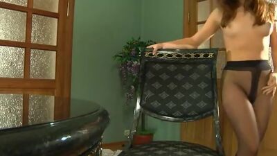 Fiery gal stuffing her nylon pantyhose into her mouth and her pussy at once