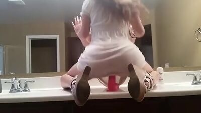 busty babe loves to ride dildo in the bathroom