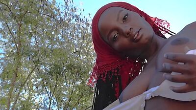 Ebony African big natural tits MILF model Shasta Wonder strips outdoor